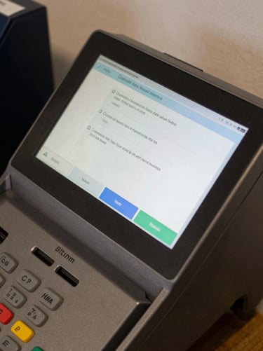 Close-up overhead of a payment terminal screen displaying a completed transaction confirmation in daylight, no people, clean studio light on the interface