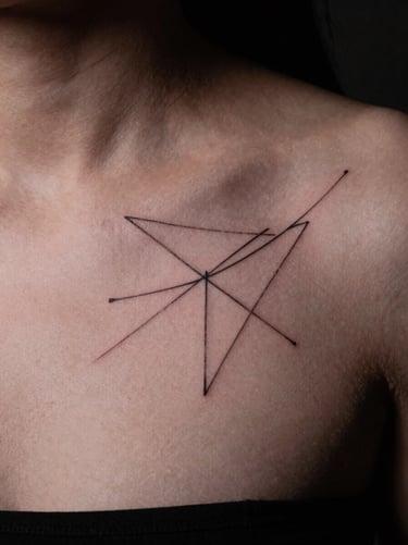 Sharp macro shot of a delicate fine-line abstract geometric tattoo on a collarbone, clean skin texture, moody studio key light, 35mm film
