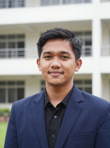 Medium close-up portrait of a male Indonesian student leader in a navy blue blazer, natural lighting, looking professional and friendly, clean campus background, sharp focus, 35mm.