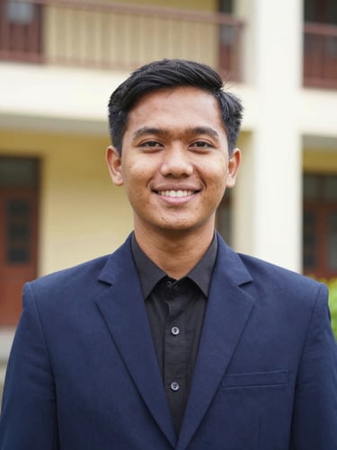 Medium close-up portrait of a male Indonesian geophysics student leader wearing a professional navy blue organization blazer, smiling confidently, clean academic background, sharp focus, 35mm.