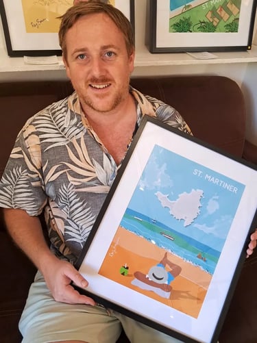 Artist smiling while holding a framed beach-themed print titled "Cloud Spotting"