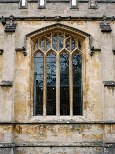 Close-up of historic stone facade and gothic window of a northern European university, overcast daylight, 35mm film look