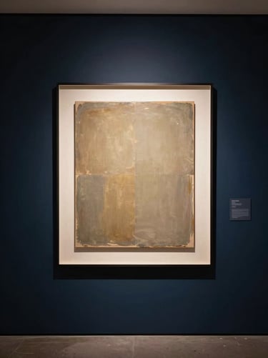 A lifestyle photograph of a modern, quiet gallery space. On a Midnight Navy wall, a large backlit art piece glows softly with Muted Gold light, casting a sophisticated and innovative atmosphere over the room.