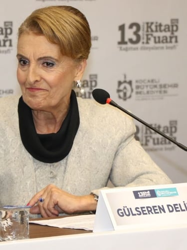 a woman in a gray sweater and black scarf