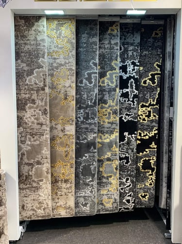 a display of a variety of different types of carpets