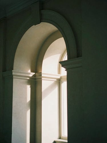 Structured architectural detail of a Chelsea stone archway, soft morning shadows, elegant and restrained framing, moody green tones, 35mm film