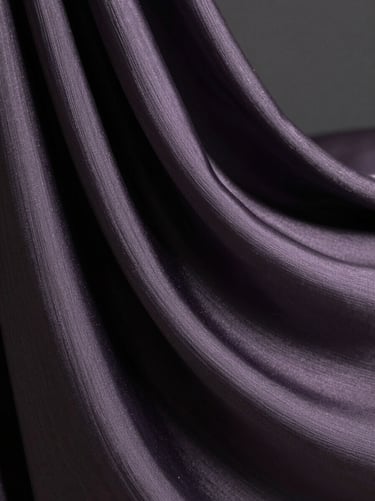 Extreme close-up of abstract digital silk drapery in motion, deep charcoal tones with metallic lavender threads