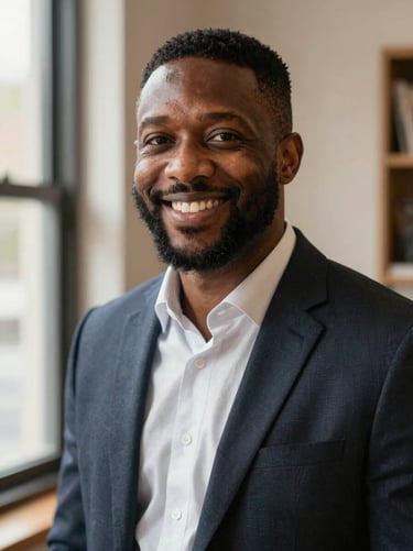 Warm environmental portrait of a friendly African American male insurance professional, smiling, soft natural lighting, trustworthy and professional