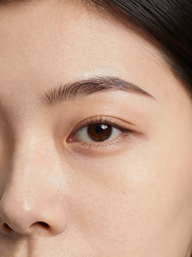 Close-up of forehead showing fine expression lines under soft directional studio lighting, 35mm clinical aesthetic