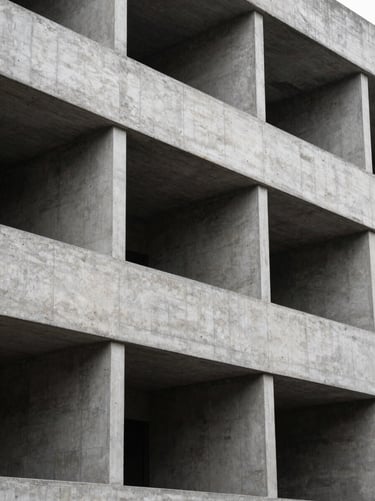 Highly structured architectural concrete facade with stark geometric shadows under diffused daylight.