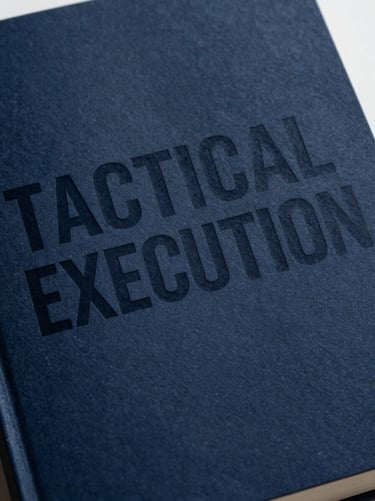 Extreme close-up of a physical book cover with a bold minimalist title 'TACTICAL EXECUTION' in heavy technical sans-serif, deep navy paper texture, sharp studio light.