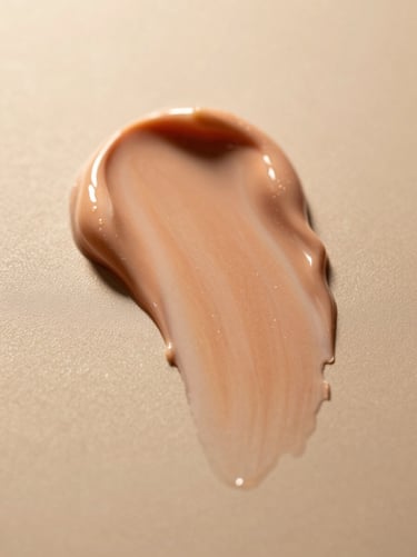 Soft cream texture smeared on a warm beige background, macro shot