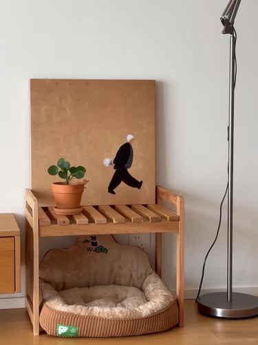 Wooden pet furniture with a soft beige cat bed, small plant and calm neutral materials in a modern a