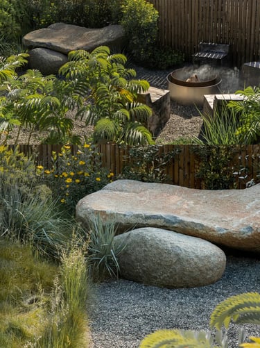 Natural garden corner with stone seating, gravel, plants and weathered textures, showing how outdoor