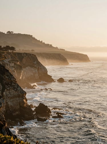 Dramatic coastal cliffs of Santa Cruz overlooking the Pacific ocean, soft sea mist, warm sunset glow, editorial lifestyle photography