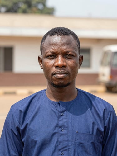 Headshot of a Nigerian male investigative reporter in Abuja, natural daylight, professional documentary style, sharp focus.
