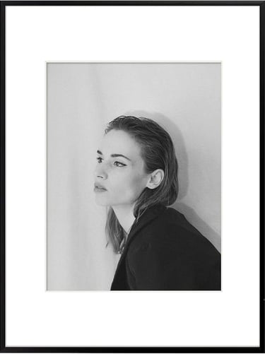 Single minimalist wall frame for adding personal memories to bedroom decor.