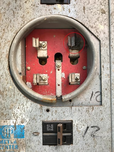 Burnt clip on electric meter base