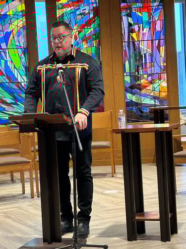 a man in a suit and tie is standing at a podium with a microphone