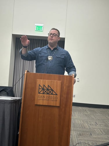 a man standing at a podium with a microphone