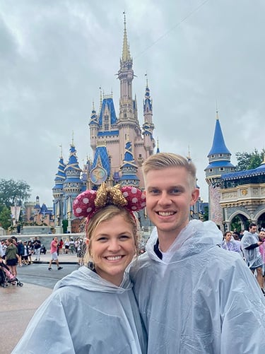 Kasey Kalk pictured with her husband in front of Cinderella Castle at Disney's Magic Kingdom®.