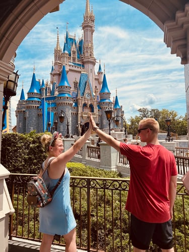 Kasey Kalk pictured with her husband in front of Cinderella Castle at Disney's Magic Kingdom®.