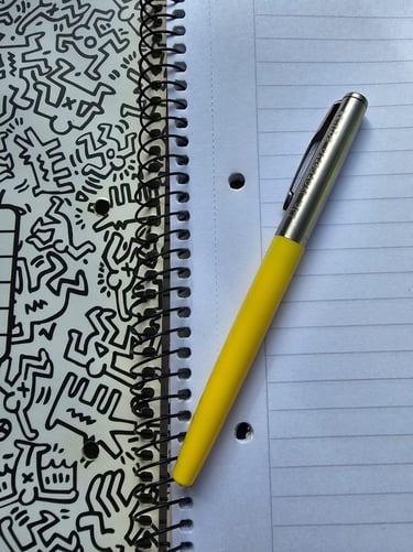 A yellow pen over an open notebook ready for create content.
