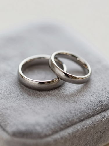 An artistic close-up of wedding rings placed on a velvet surface, showcasing timeless photography and professional detail, featuring the #F5F2F0 and #3A3335 palette.