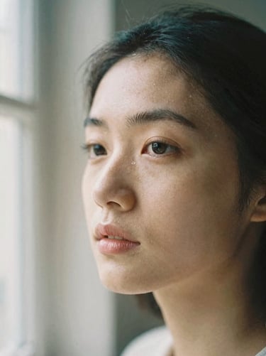 A close-up portrait focusing on texture and genuine expression, soft natural window light, muted neutral tones, shallow depth of field