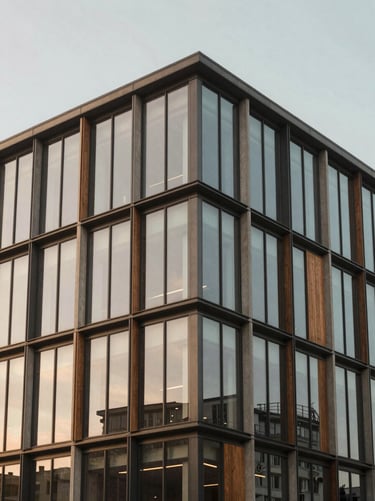 Modern commercial office building exterior, geometric steel and glass structure, soft morning light, 35mm lens