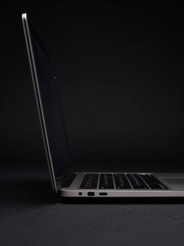 MacBook Air M2 dark aluminum chassis, side profile, sharp rim light, black background