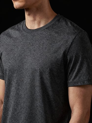 Close-up of a premium charcoal grey t-shirt on a model, high-contrast studio lighting, soft shadows, 85mm lens