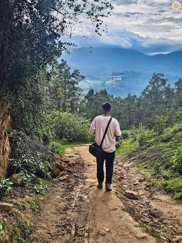 Trekking the muddy trail to Poondi Lake, surrounded by lush greenery and rolling hills.