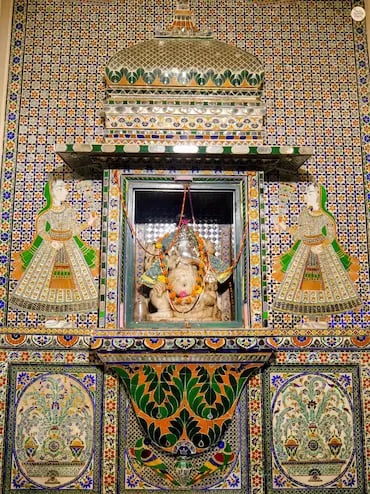Colorful glass and tile patterns inside Ganesh Deodi, Udaipur City Palace museum entry gate.
