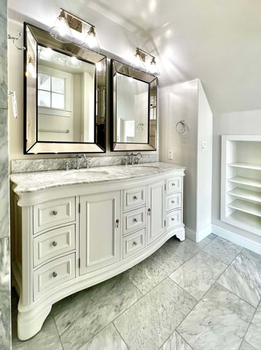 Bathroom with traditional architectural style, beautiful radius wood vanity, and marble countertops.