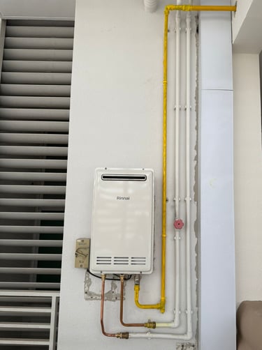 a tankless water heater with a yellow hose and a yellow hose