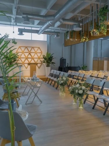 a room with chairs and tables and plants