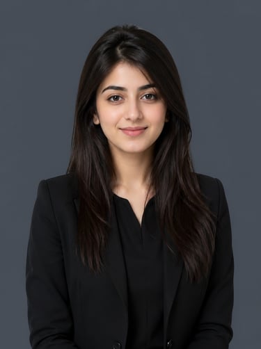 Professional corporate headshot of a young woman with long dark hair wearing a black blazer.
