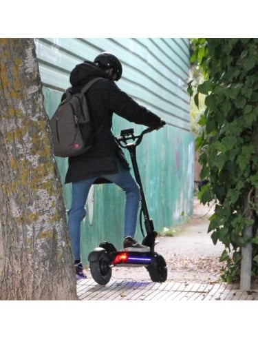 a person riding a scooter on a sidewalk