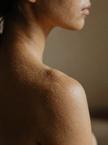 Soft focus photography of a human shoulder and neck in intimate Warm sand light, grainy texture, South American / Argentine interior.