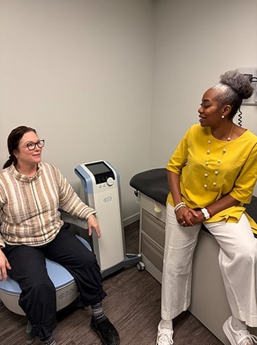a woman sitting on BTL Emsella chair to strengthen pelvic muscles talking to dr aluko