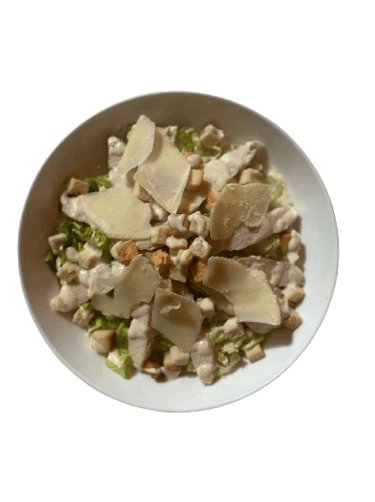 a bowl of food with cheese and vegetables