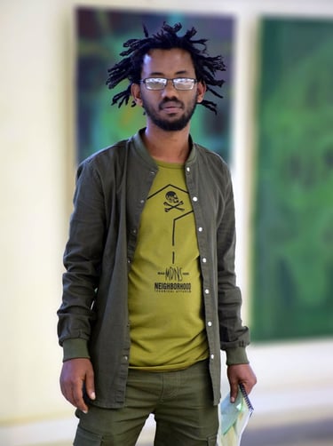 a man with dreadlocks and a green shirt