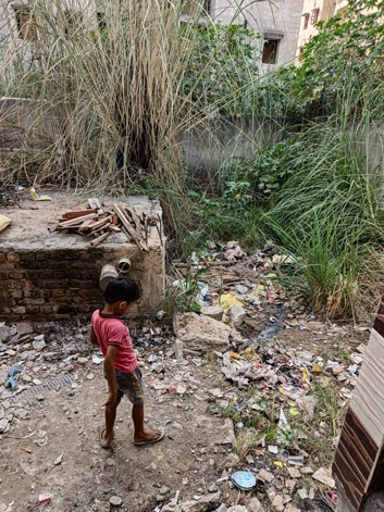 Young boy in dilapidated slum area in Delhi