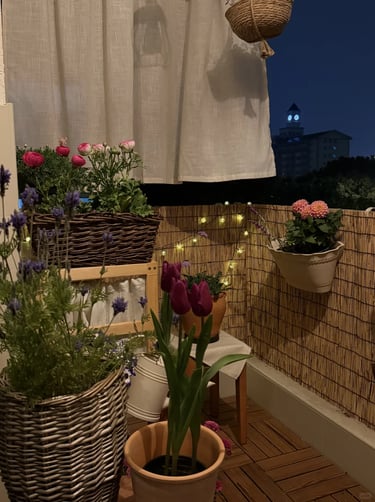 Potted plants placed near a balcony reading corner, creating a soft, private, and natural evening at