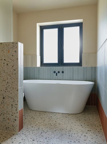 large-format terrazzo tiles strong contrasting tile strip in a wet room 