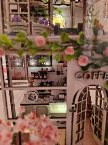 Coffee Garden book nook, miniature café details, plants, and warm interior lighting.