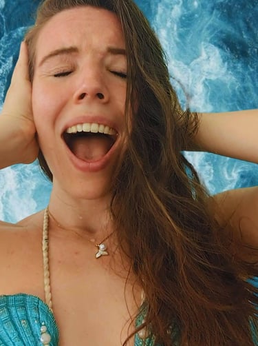a person dressed up as mermaid, screaming in frustration with an ocean background