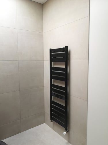 sèche serviette noir moderne sur faïence grand carreaux minérales, douche moderne italienne.