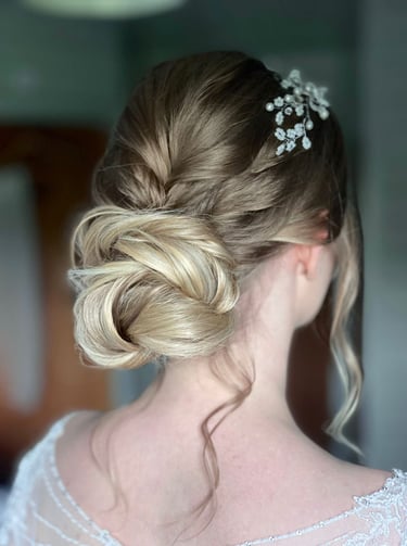 a woman with wedding hair with a flower in her hair